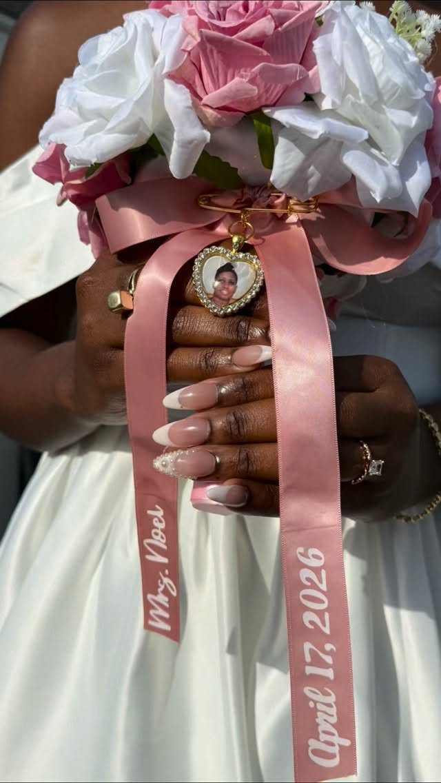 Sister Wedding Gift Ideas: 34 Picks She'll Treasure 5 Heart-shaped gold locket with photo attached to a wedding bouquet pink ribbon