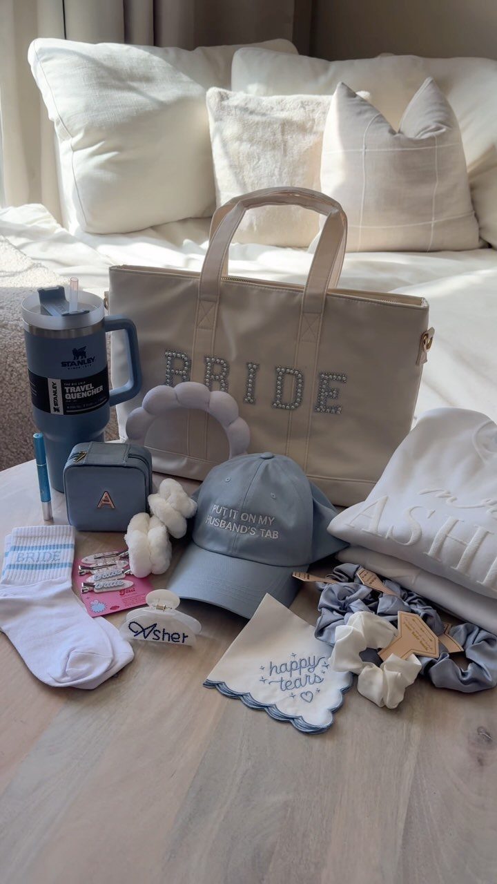 Sister Wedding Gift Ideas: 34 Picks She'll Treasure 7 Bridal gift set featuring a rhinestone bride tote, grey cap, and white accessories.