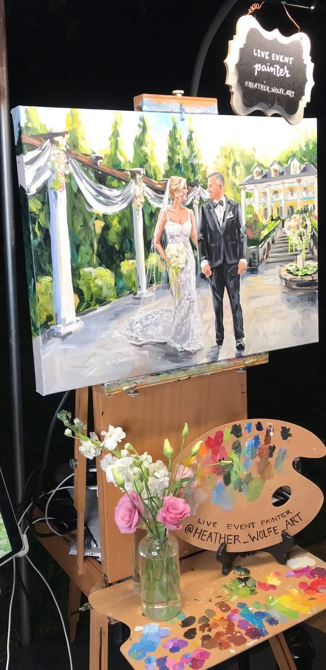 Sister Wedding Gift Ideas: 34 Picks She'll Treasure 22 Wedding painting of a couple on an easel with a paint palette and flowers.