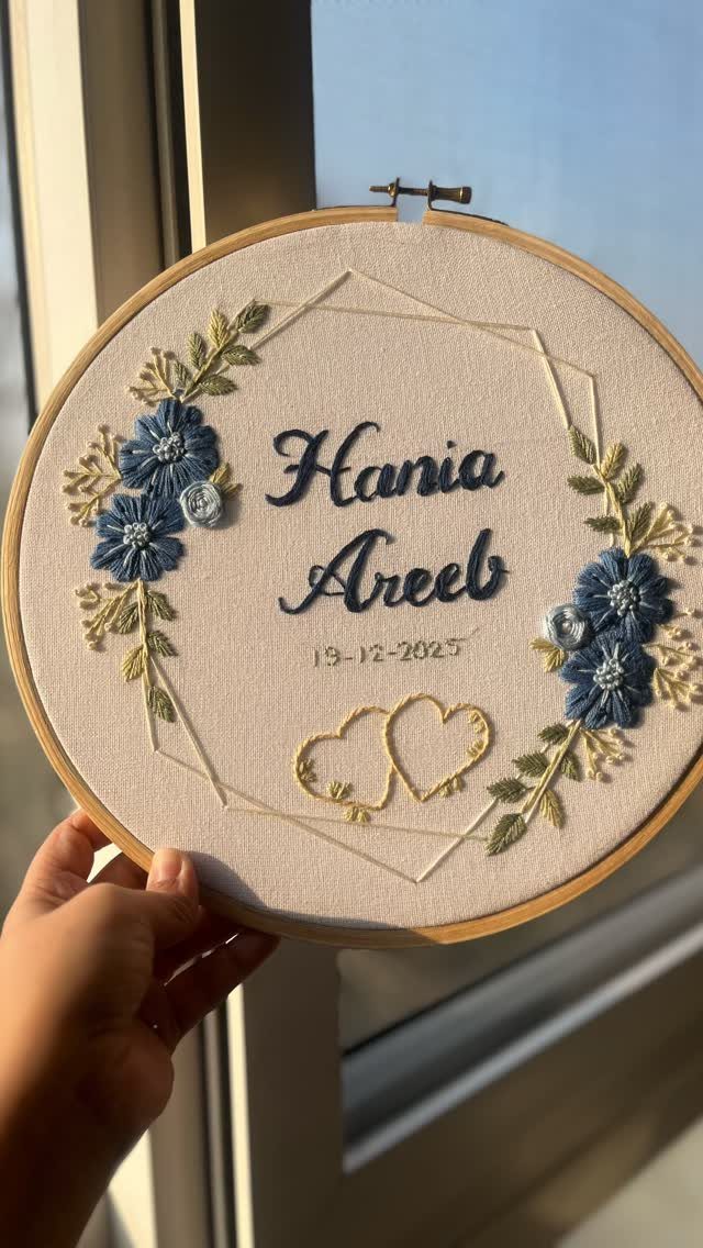 20 Small Wedding Gift Ideas for Couples Who Have Everything 20 Embroidered wedding gift in a wooden hoop featuring names, date, and blue flowers.