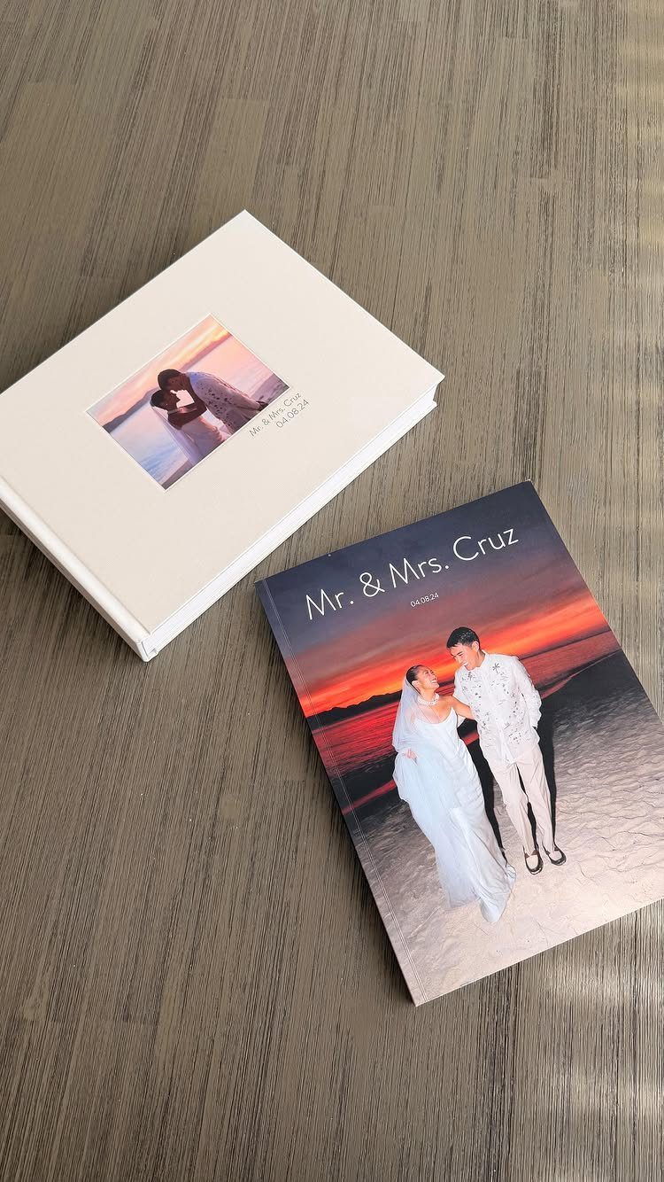 20 Small Wedding Gift Ideas for Couples Who Have Everything 10 Two wedding photo albums featuring a couple on the covers on a grey table.