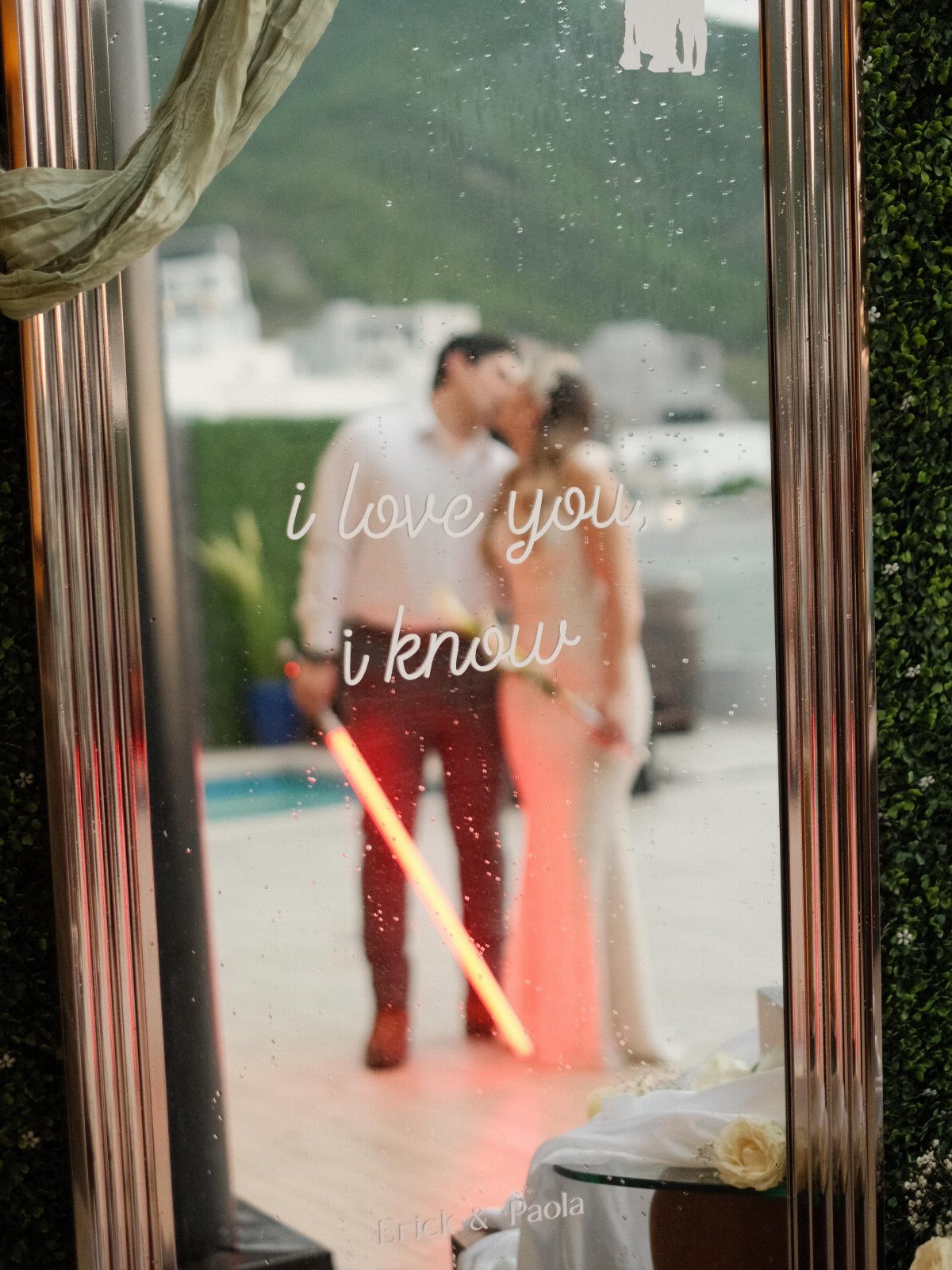 Mirror with Star Wars quote reflecting a wedding couple with a red lightsaber