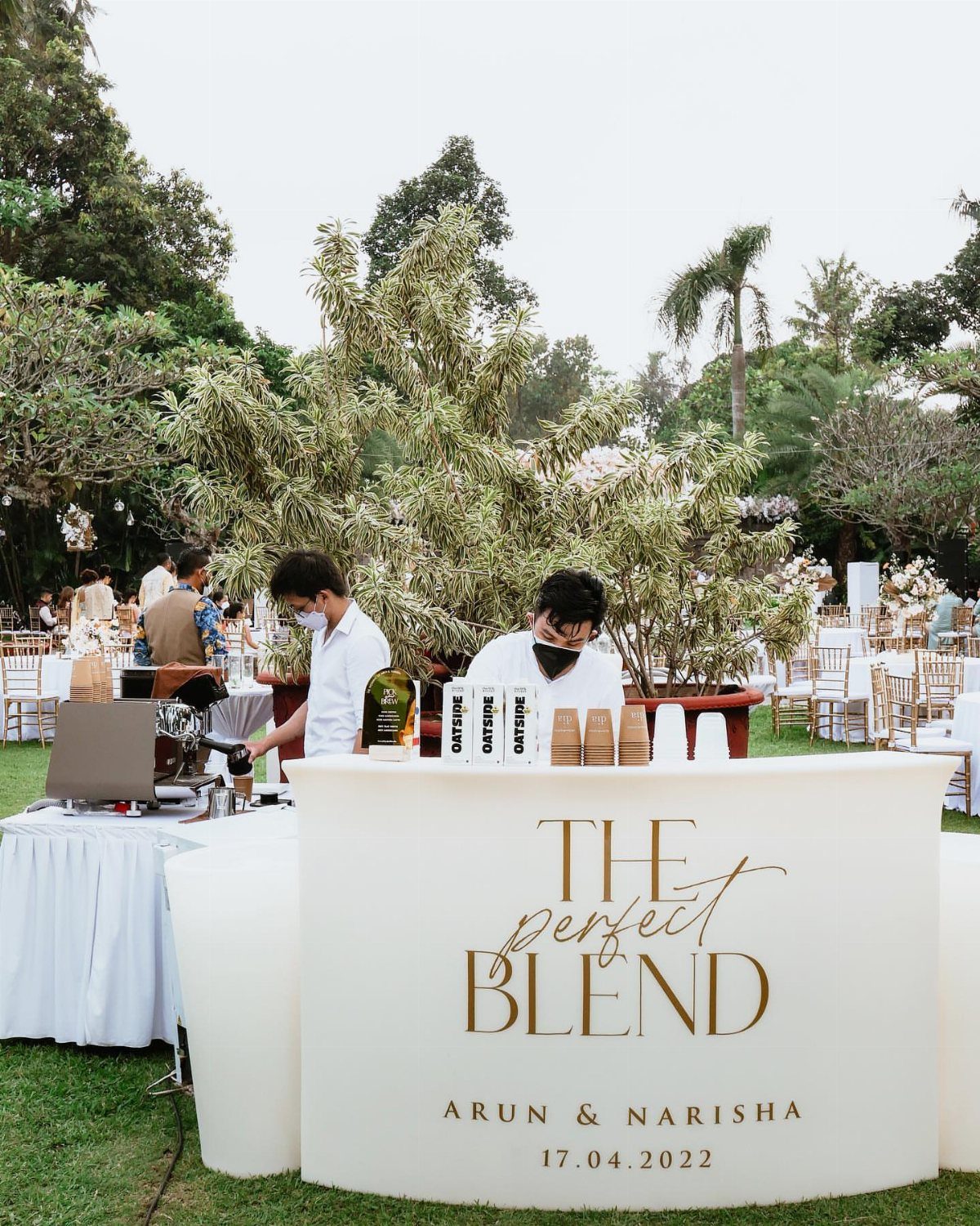35 Backyard Wedding Reception Ideas for an Unforgettable Day 22 Outdoor coffee station with a white curved bar and two baristas preparing drinks.