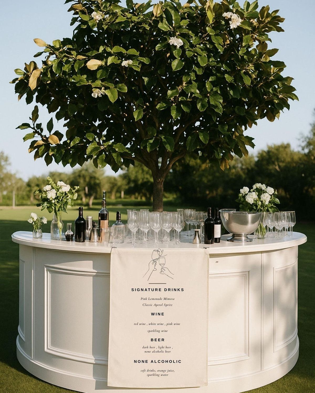 35 Backyard Wedding Reception Ideas for an Unforgettable Day 18 Curved white outdoor bar with wine, glasses, and flowers under a green tree