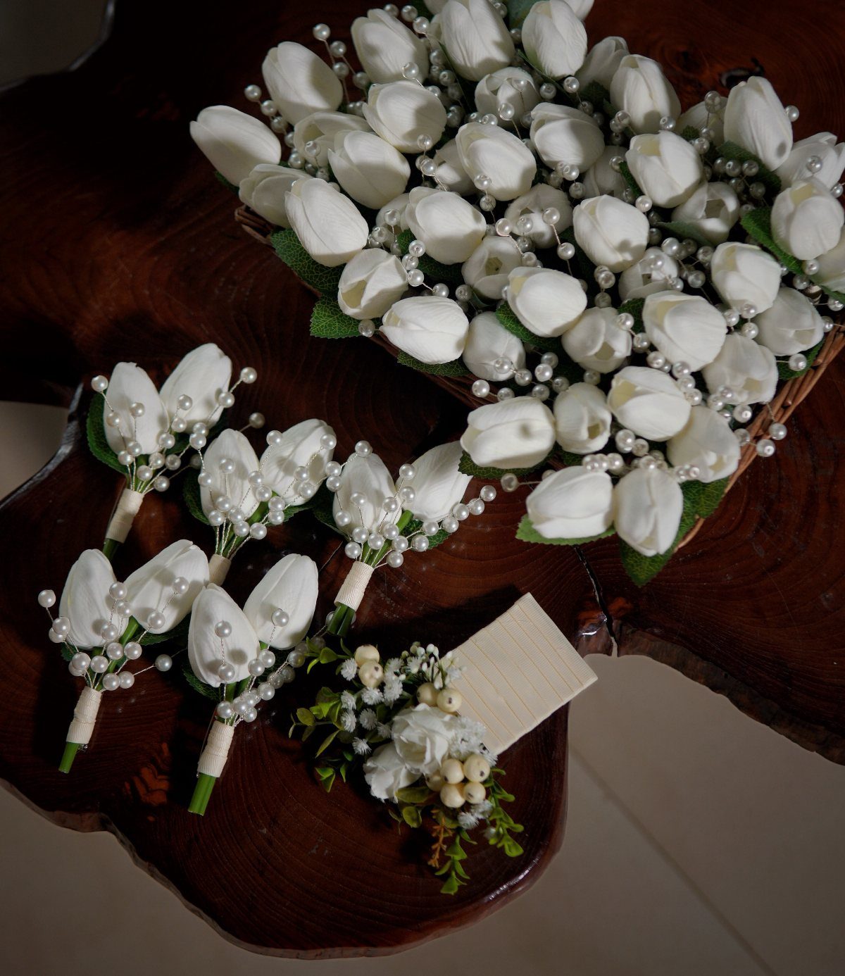 12 Wedding Bouquet Alternatives for Your Big Day 8 White fabric tulip bouquets with pearl accents on a dark wooden table