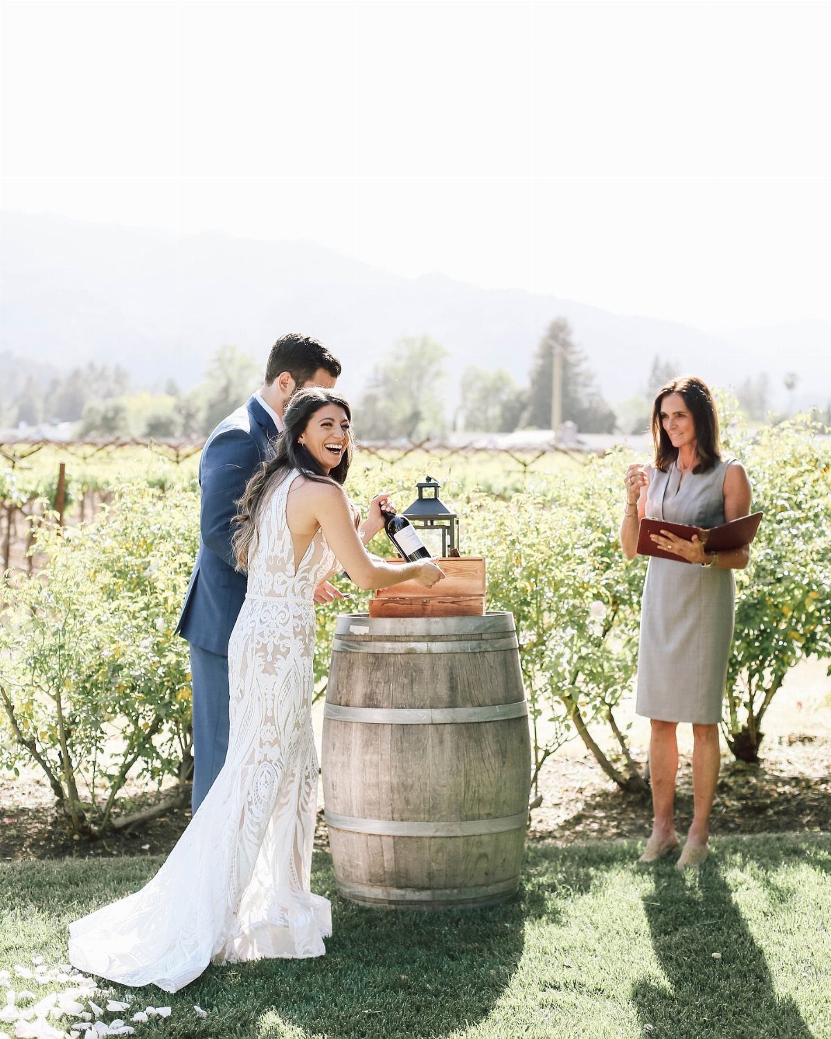 Bride and groom performing a wine unity ceremony at a vineyard wedding.