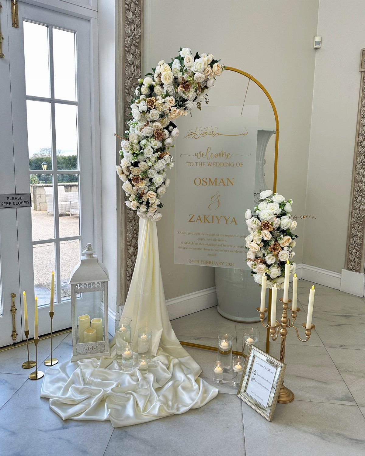 Wedding Decor Brown: How to Use It in 8 Elegant Ways 8 An arched acrylic wedding welcome sign decorated with cream roses and draped white fabric.
