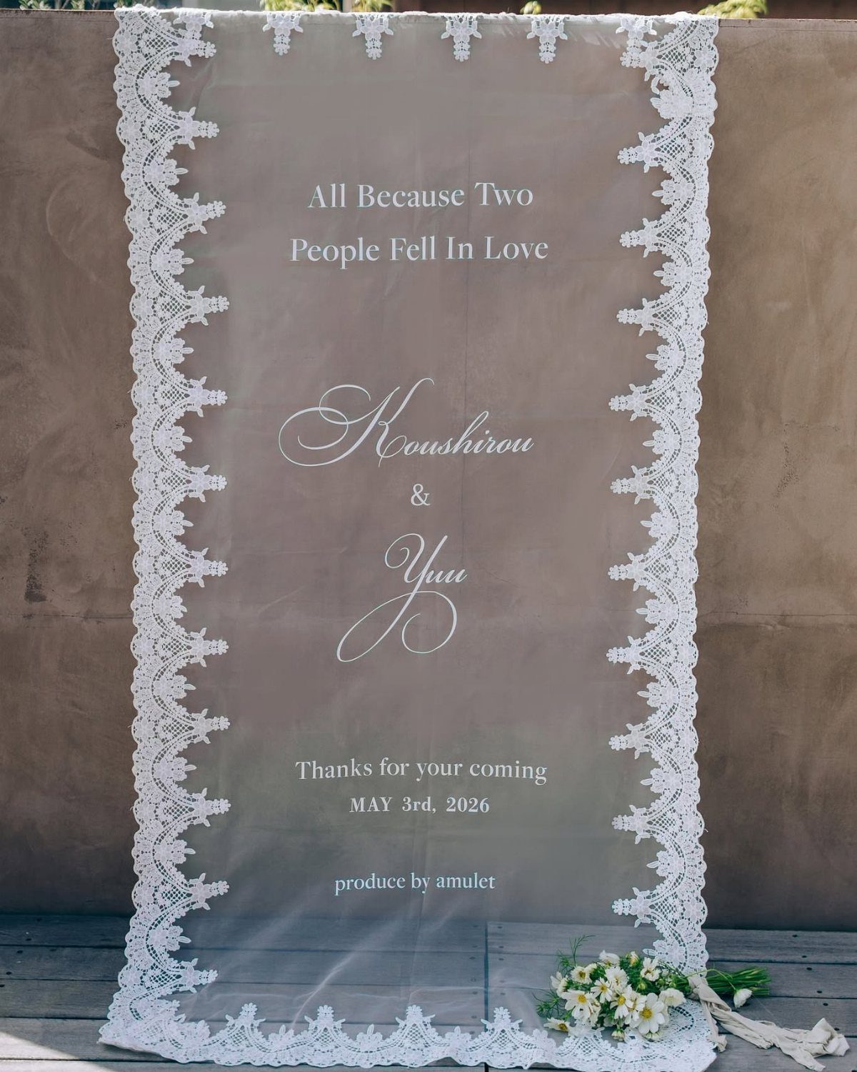 Wedding Decor Quotes: 7 Display Ideas From Letterboard to Acrylic 5 A sheer white lace-edged tapestry hanging outdoors with romantic wedding text and names.