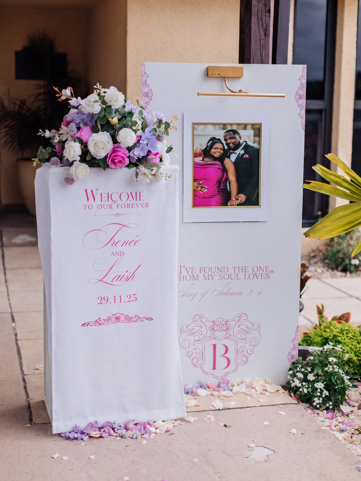 Wedding Decor Quotes: 7 Display Ideas From Letterboard to Acrylic 4 Two white wedding signs with pink lettering and floral decorations standing on a stone walkway.
