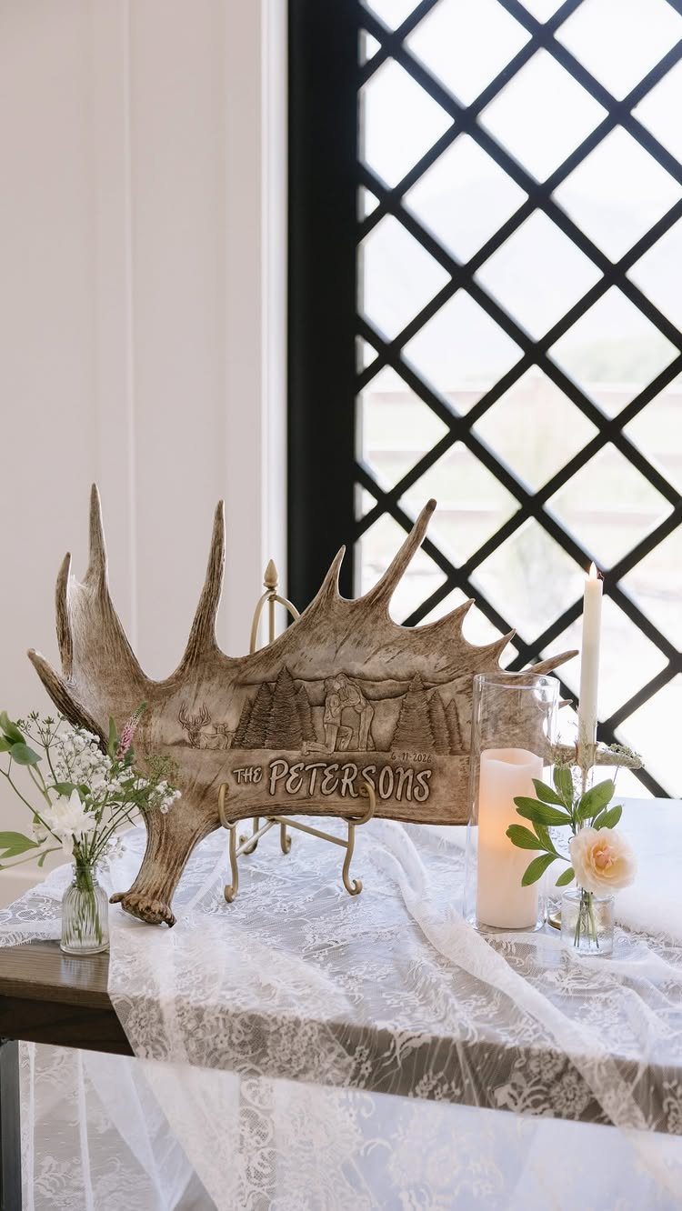 Wedding Decor with Western Style: 21 Ideas from Ranch to Aisle 4 A large moose antler sign reading The Petersons on a lace-covered table with flowers.