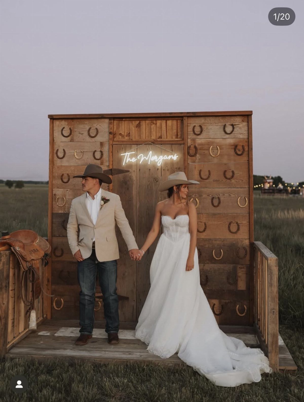 Wedding Decor with Western Style: 21 Ideas from Ranch to Aisle 17 A bride and groom posing in front of a western-themed wooden backdrop with horseshoes.