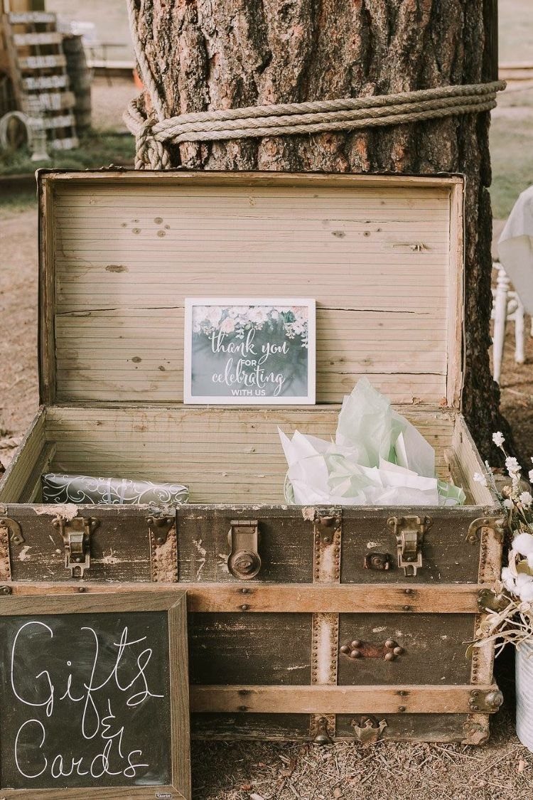Wedding Decor with Western Style: 21 Ideas from Ranch to Aisle 20 An open vintage wooden trunk containing gifts and a thank you sign next to a chalkboard.