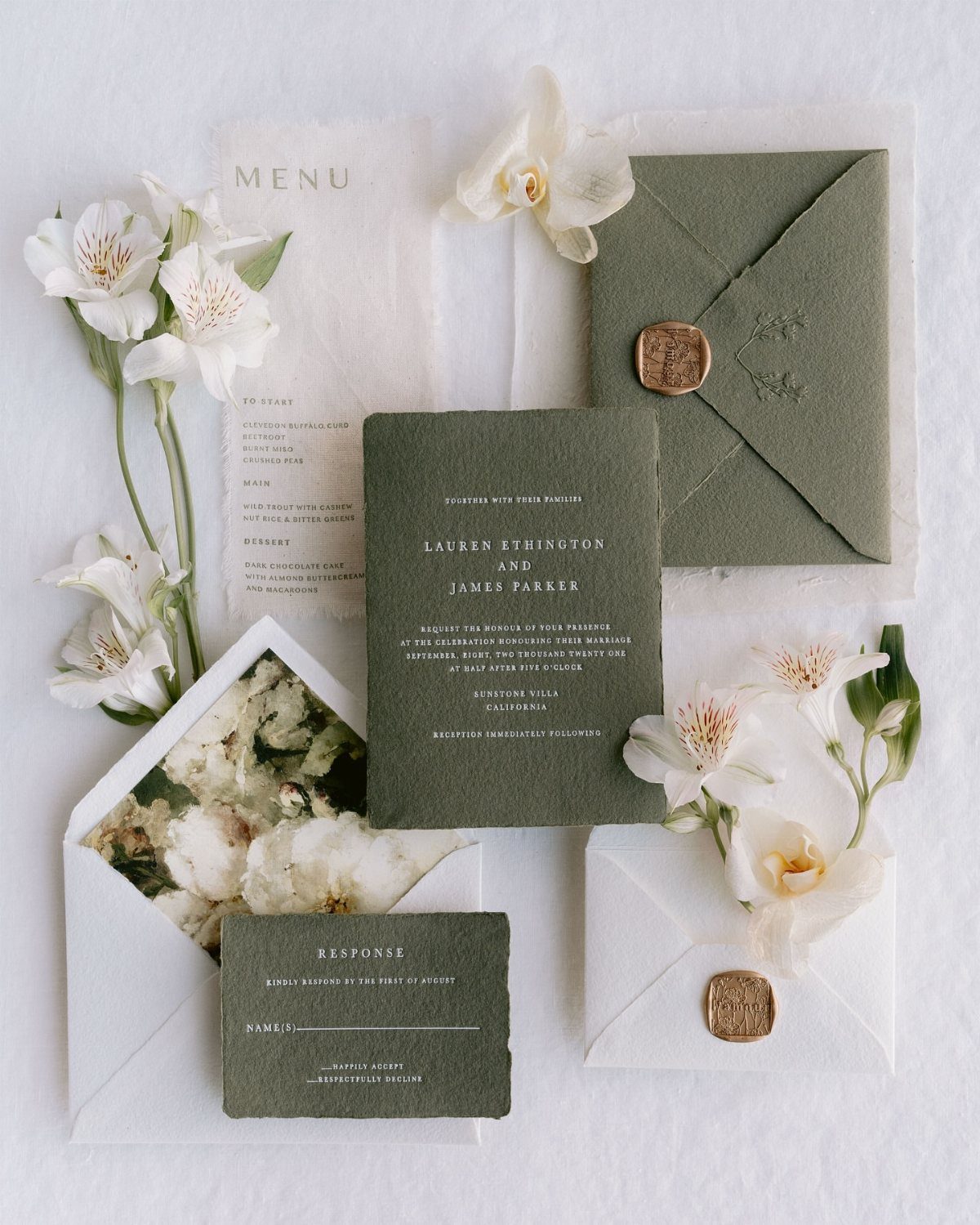 Wedding Detail Shots: 21 Ideas for Your Photographer 3 Sage green wedding invitation suite with white flowers and wax seals on a white background.