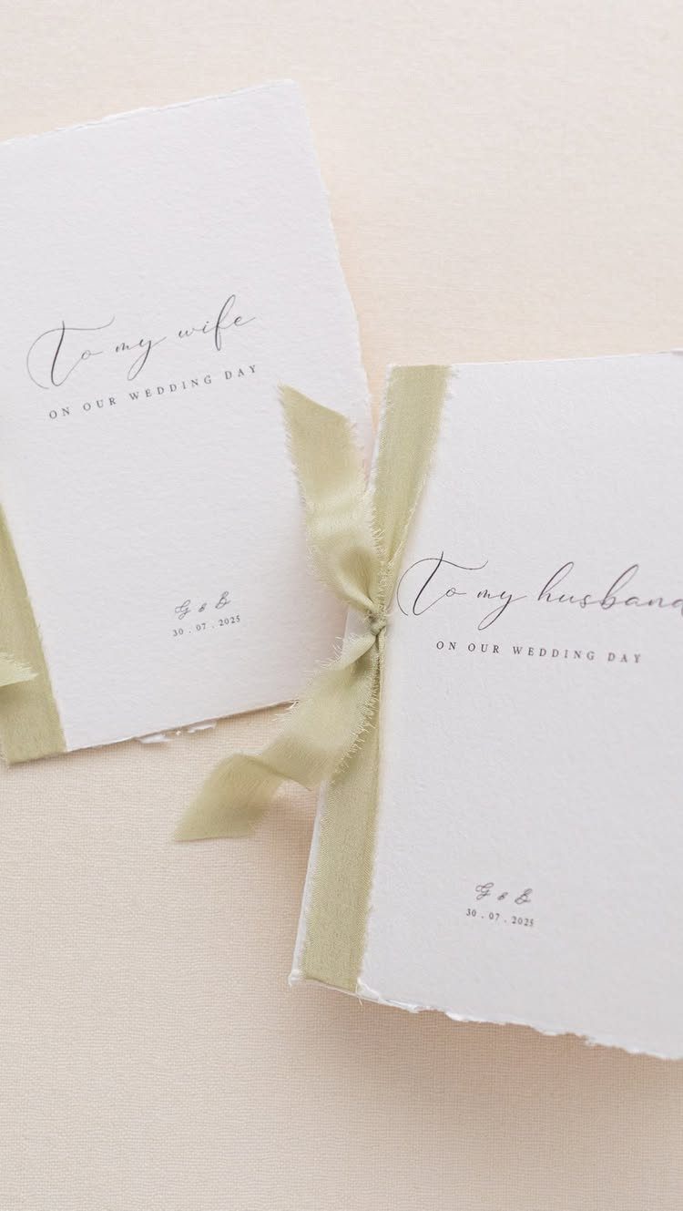 Wedding Detail Shots: 21 Ideas for Your Photographer 18 Two white deckled-edge wedding day cards tied with sage green ribbons on a neutral background.