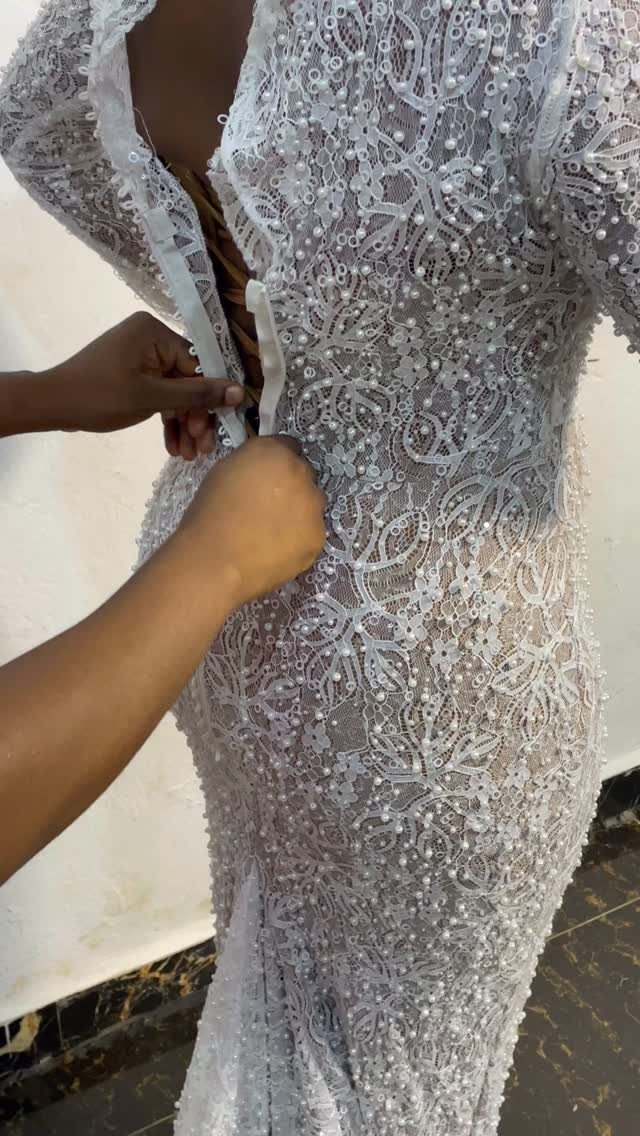Tight Lace Wedding Dresses in 25 Beautiful Styles 13 White lace wedding dress with intricate 3-D beaded floral patterns being fitted.