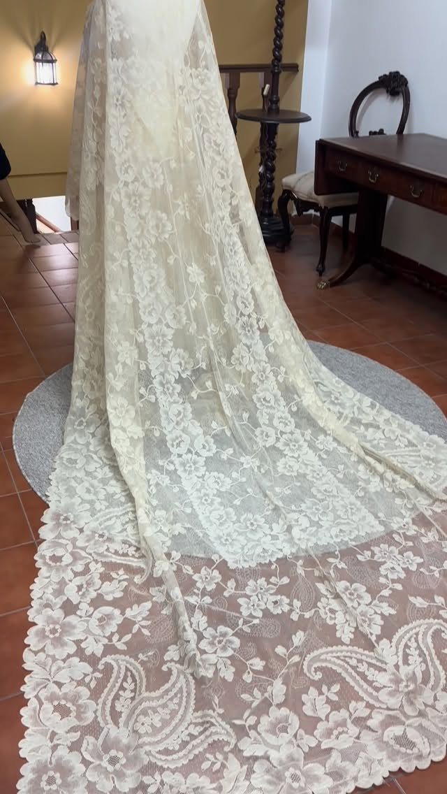 Tight Lace Wedding Dresses in 25 Beautiful Styles 10 Ivory lace wedding dress train with floral motifs and scalloped edges on a rug.