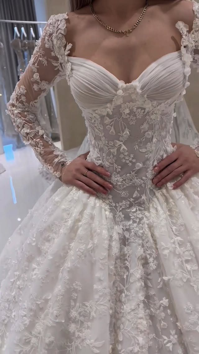 Tight Lace Wedding Dresses in 25 Beautiful Styles 8 White ball gown wedding dress with lace corset bodice and long lace sleeves.