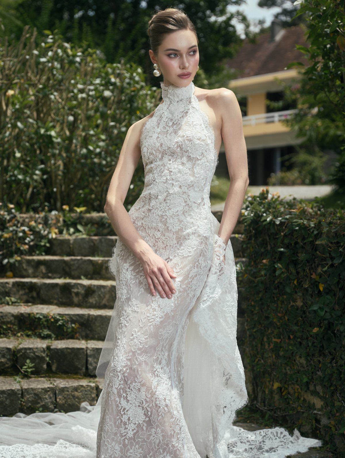 Tight Lace Wedding Dresses in 25 Beautiful Styles 25 Woman in a tight white lace wedding dress with a high halter neckline outdoors.