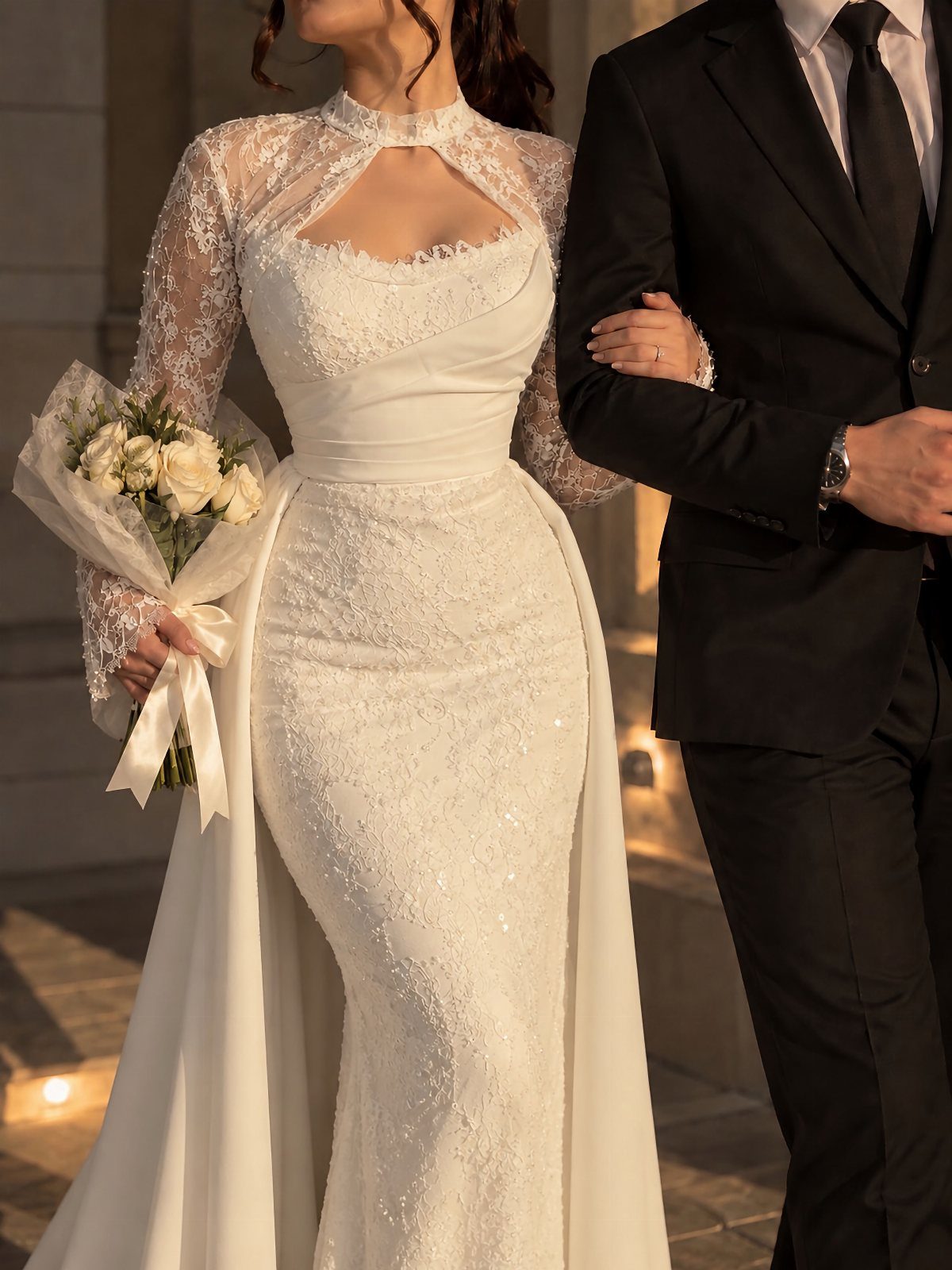 Tight Lace Wedding Dresses in 25 Beautiful Styles 21 Woman in a tight white lace wedding dress with long sleeves and overskirt.
