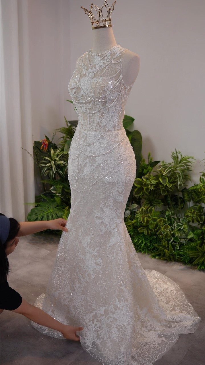 Tight Lace Wedding Dresses in 25 Beautiful Styles 2 White lace mermaid wedding dress on a mannequin with a gold crown.