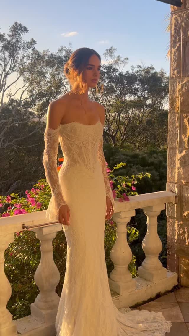 Tight Lace Wedding Dresses in 25 Beautiful Styles 6 Woman in a tight white lace wedding dress standing on a stone balcony.