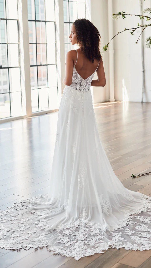 Tight Lace Wedding Dresses in 25 Beautiful Styles 18 Woman in a white wedding dress with a long lace train and bodice.
