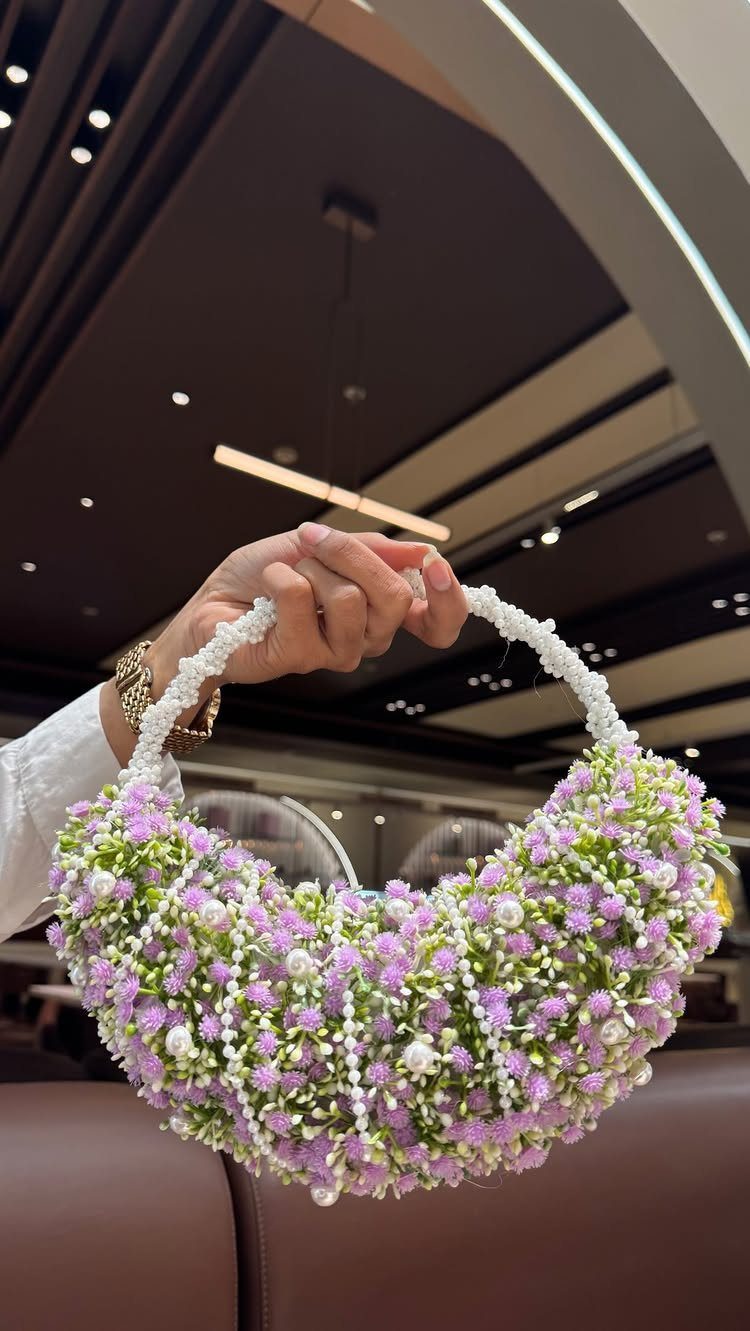 Wedding Flower Trends: 36 Ideas from Jewel Tones to Arches 13 Floral purse made of purple and white flowers held by a hand.