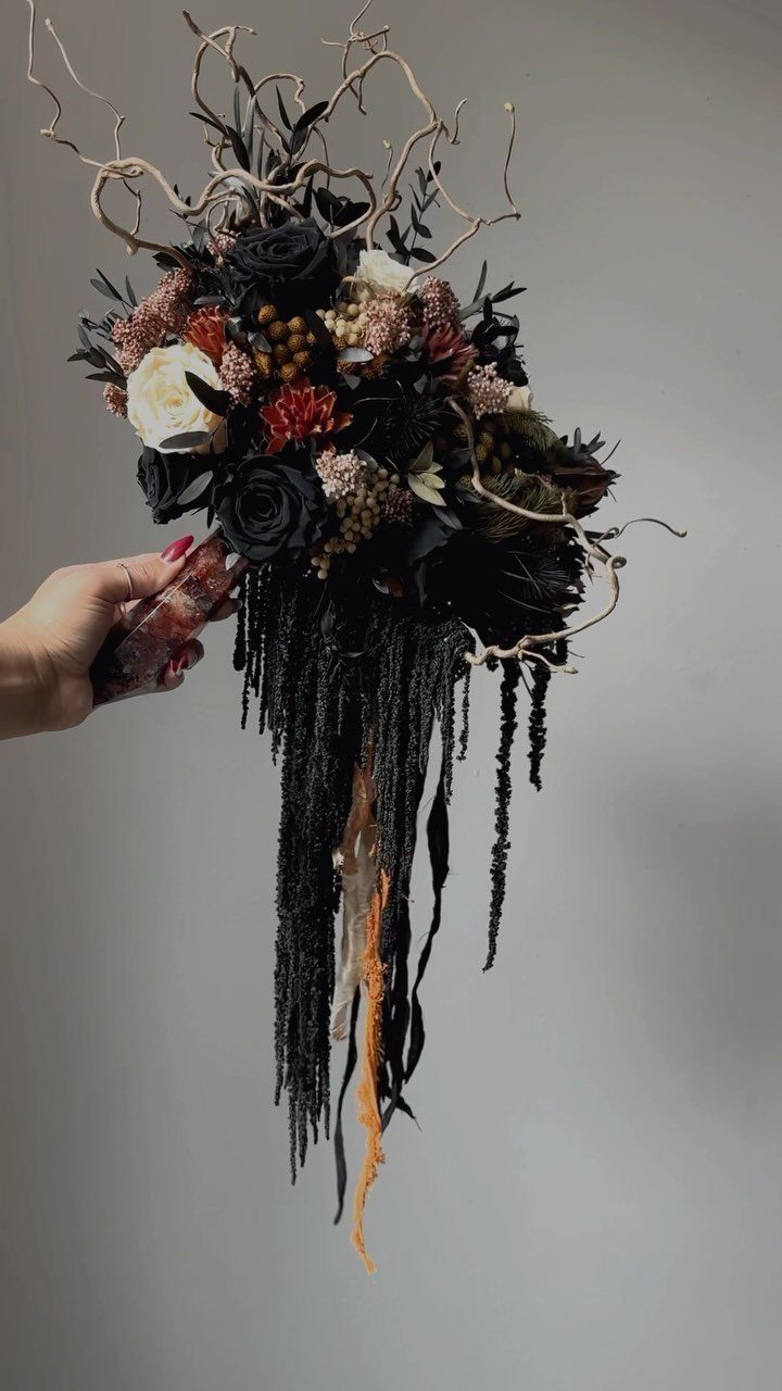 Wedding Flower Trends: 36 Ideas from Jewel Tones to Arches 34 Gothic wedding bouquet with black roses, white flowers, and long trailing black ribbons.