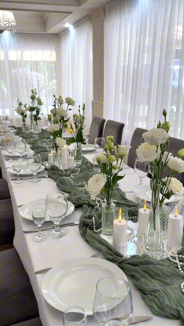 Wedding Flower Trends: 36 Ideas from Jewel Tones to Arches 22 Long white table with slender vases of white flowers and sage green runner.