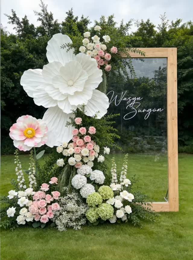 Wedding Flower Trends: 36 Ideas from Jewel Tones to Arches 30 Large white paper flowers and pink roses decorating a wooden framed glass wedding sign.