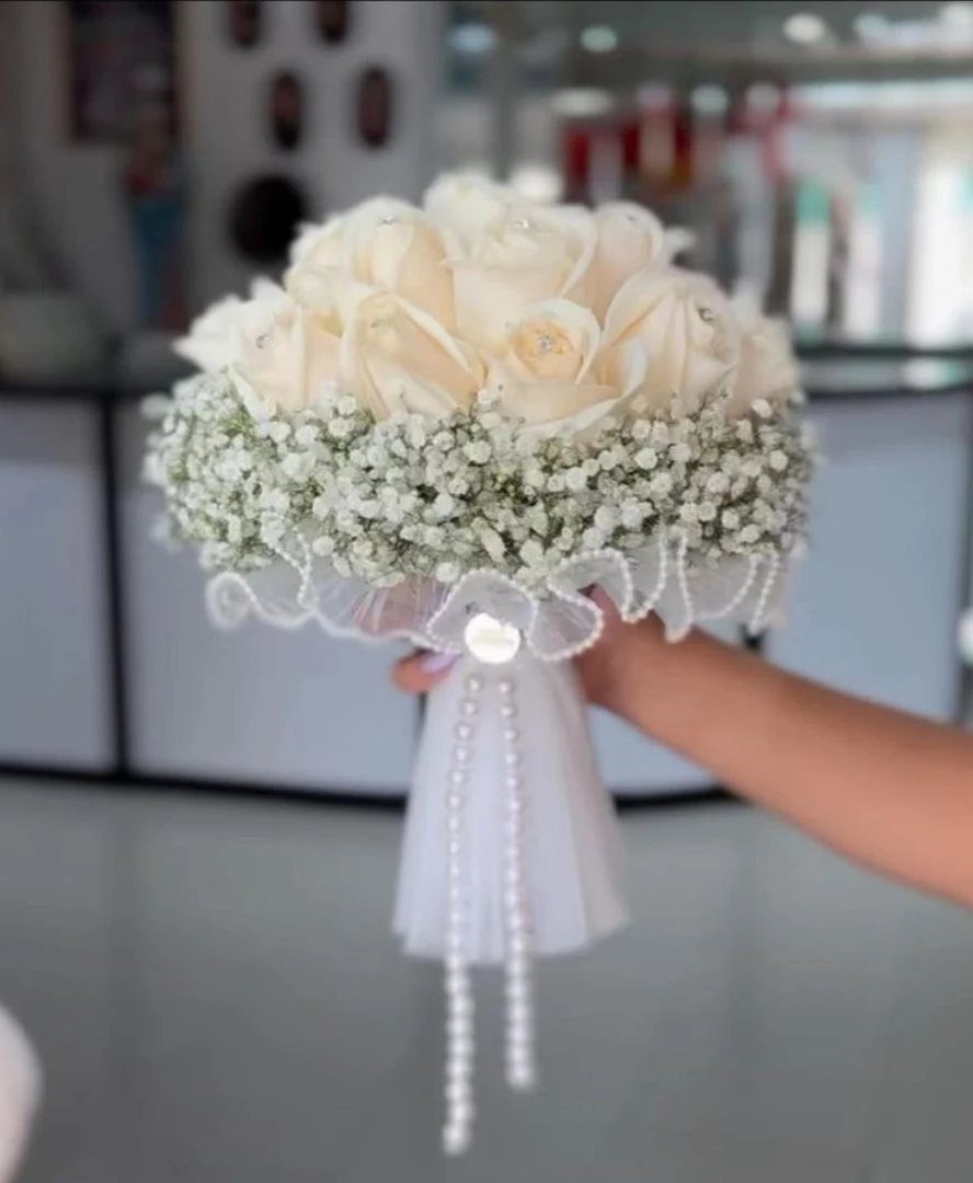 Wedding Flower Trends: 36 Ideas from Jewel Tones to Arches 11 Small bridal bouquet with cream roses, baby's breath, and pearl accents.