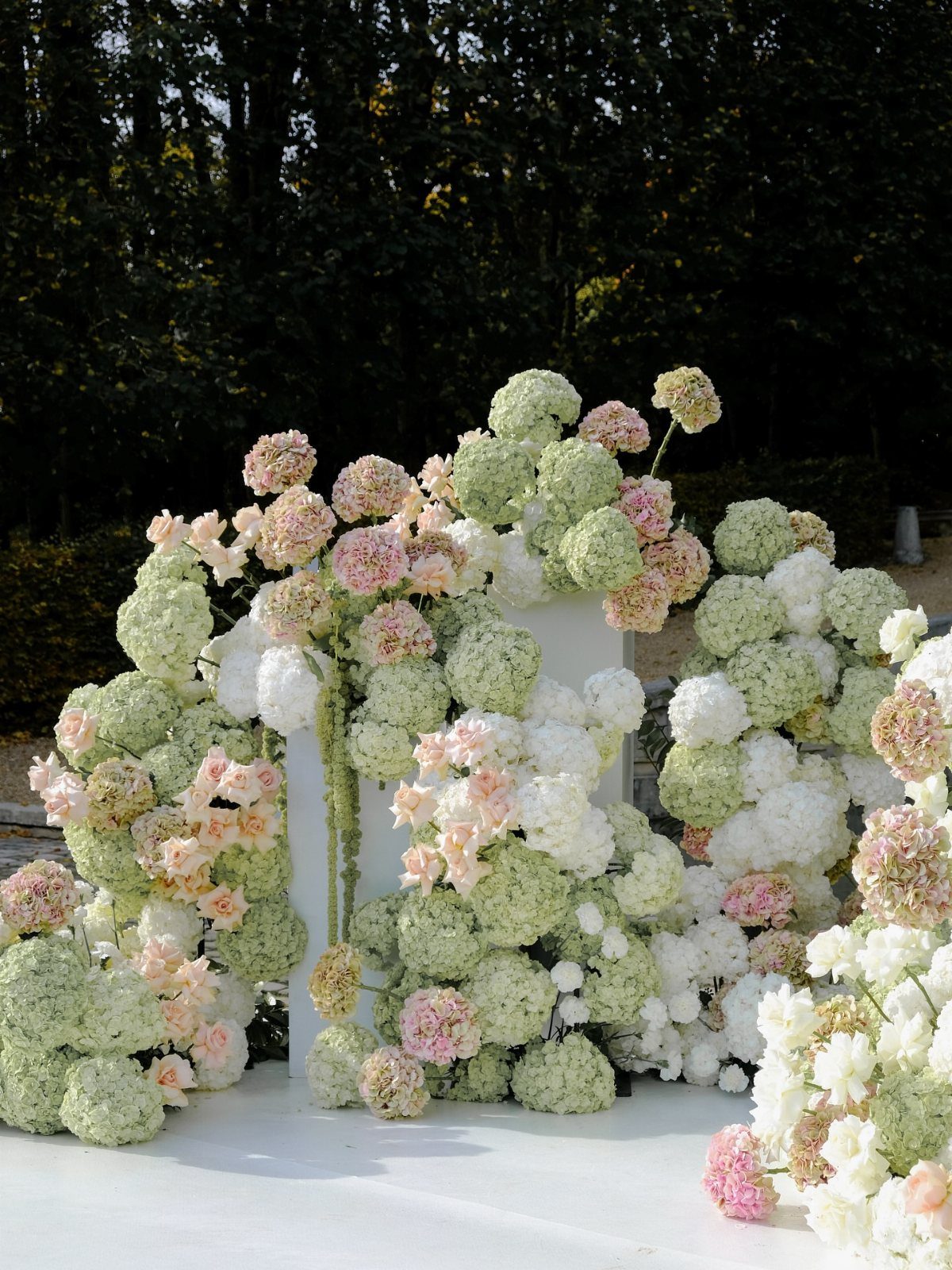 Wedding Flower Trends: 36 Ideas from Jewel Tones to Arches 16 Large sculptural installation of white, green, and pink hydrangea blooms around a white pedestal.