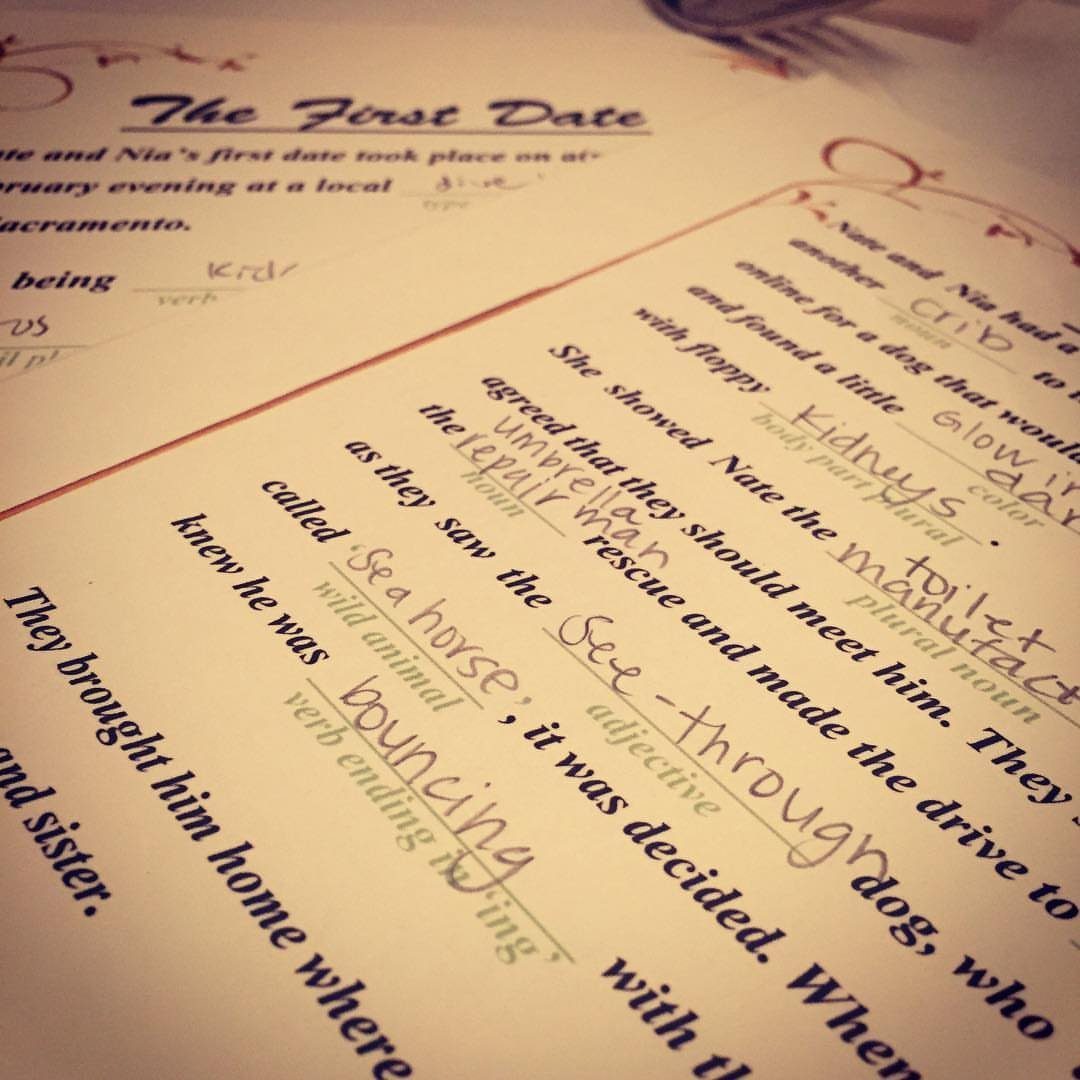 13 Wedding Games Table Ideas Your Guests Will Actually Play 3 Handwritten words filling in the blanks of a Mad Libs game titled The First Date.
