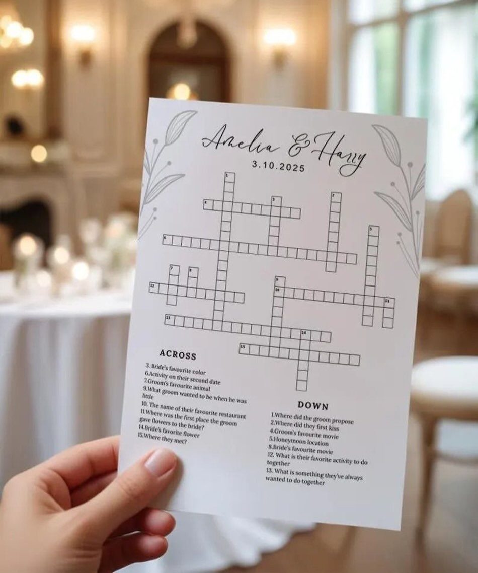 13 Wedding Games Table Ideas Your Guests Will Actually Play 9 A hand holding a custom wedding crossword game card with clues and a puzzle grid.