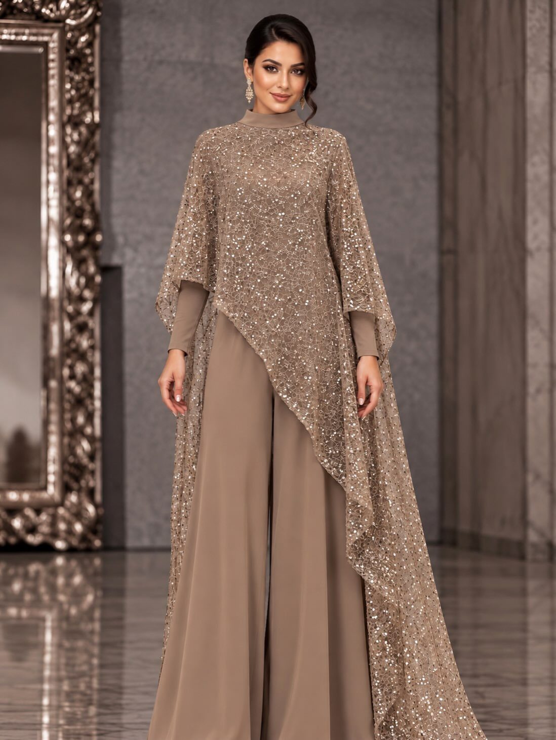 19 Wedding Guest Dress Ideas for Every Season and Style 4 Woman wearing a taupe wide-leg jumpsuit with a shimmering gold sequined cape overlay.