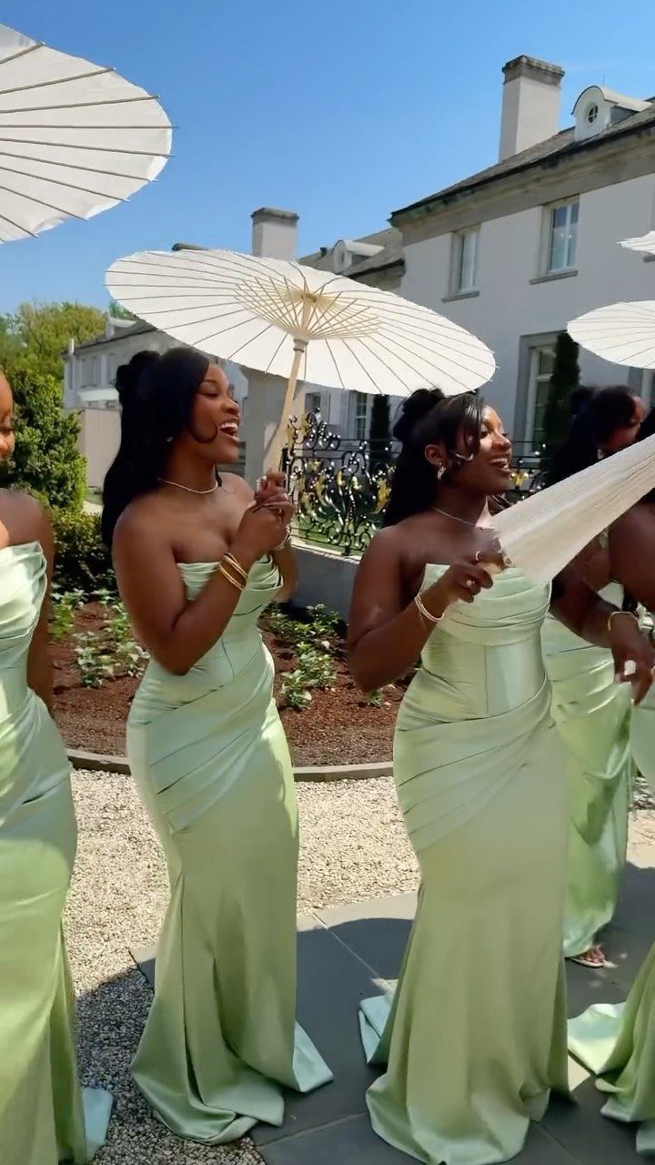 Wedding Party Colors: 13 Real Palette Ideas for Your Bridal Party 9 Bridesmaids wearing mint green satin dresses while holding white paper parasols in a sunny courtyard.