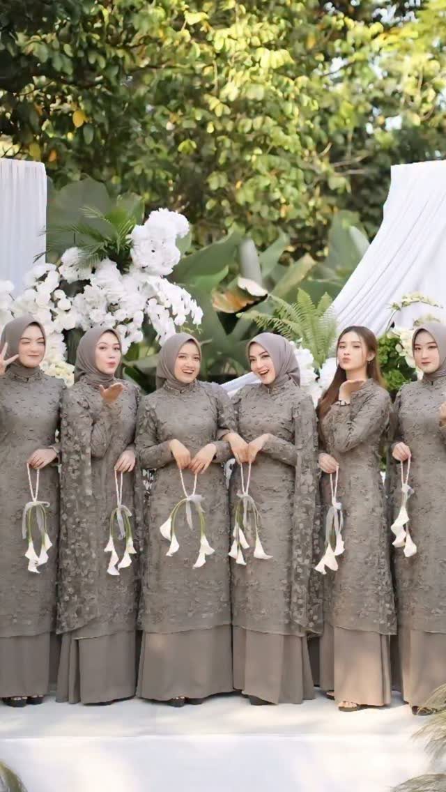 Wedding Party Colors: 13 Real Palette Ideas for Your Bridal Party 10 Six women in matching olive lace dresses holding white flowers in a garden setting.