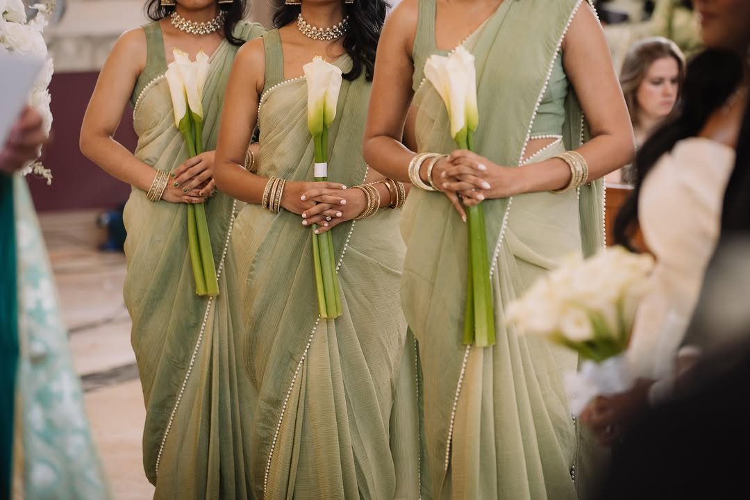 Wedding Party Colors: 13 Real Palette Ideas for Your Bridal Party 13 Three bridesmaids in sage green sarees holding single white calla lily bouquets.