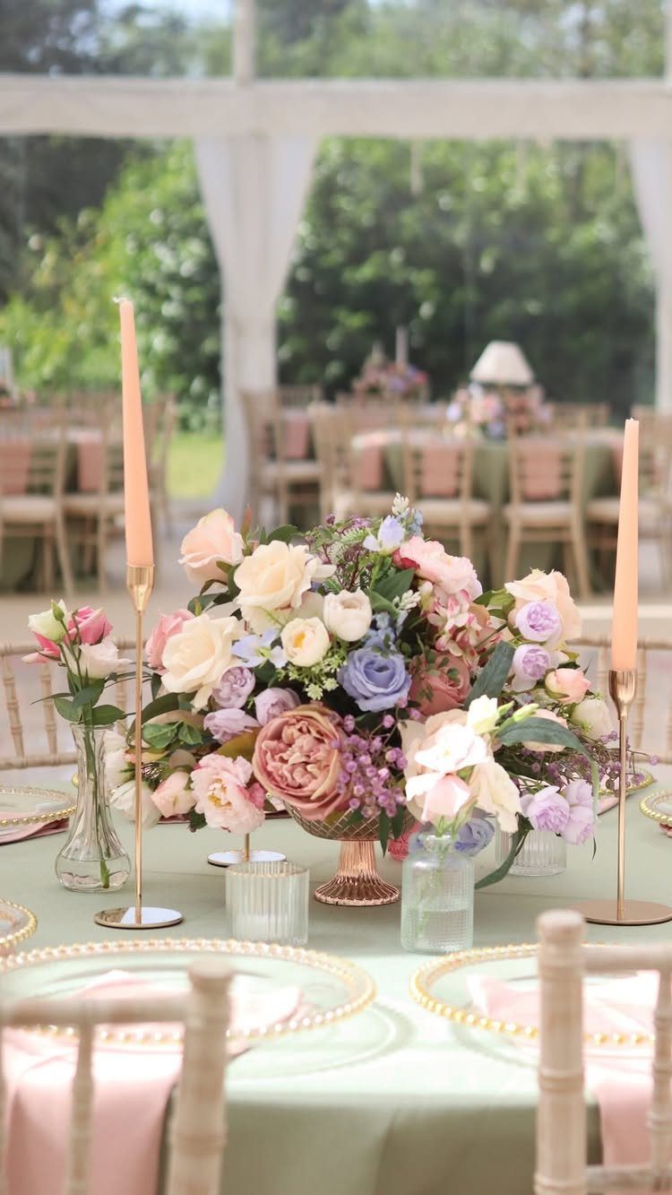 Sage green wedding table with pink napkins and a lush pink floral centerpiece.