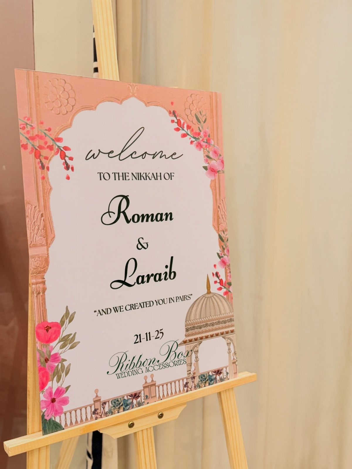 25 Wedding Stuff Ideas for Your 2026 Ceremony and Party 10 A pink welcome sign for a Nikkah ceremony displayed on a wooden easel.