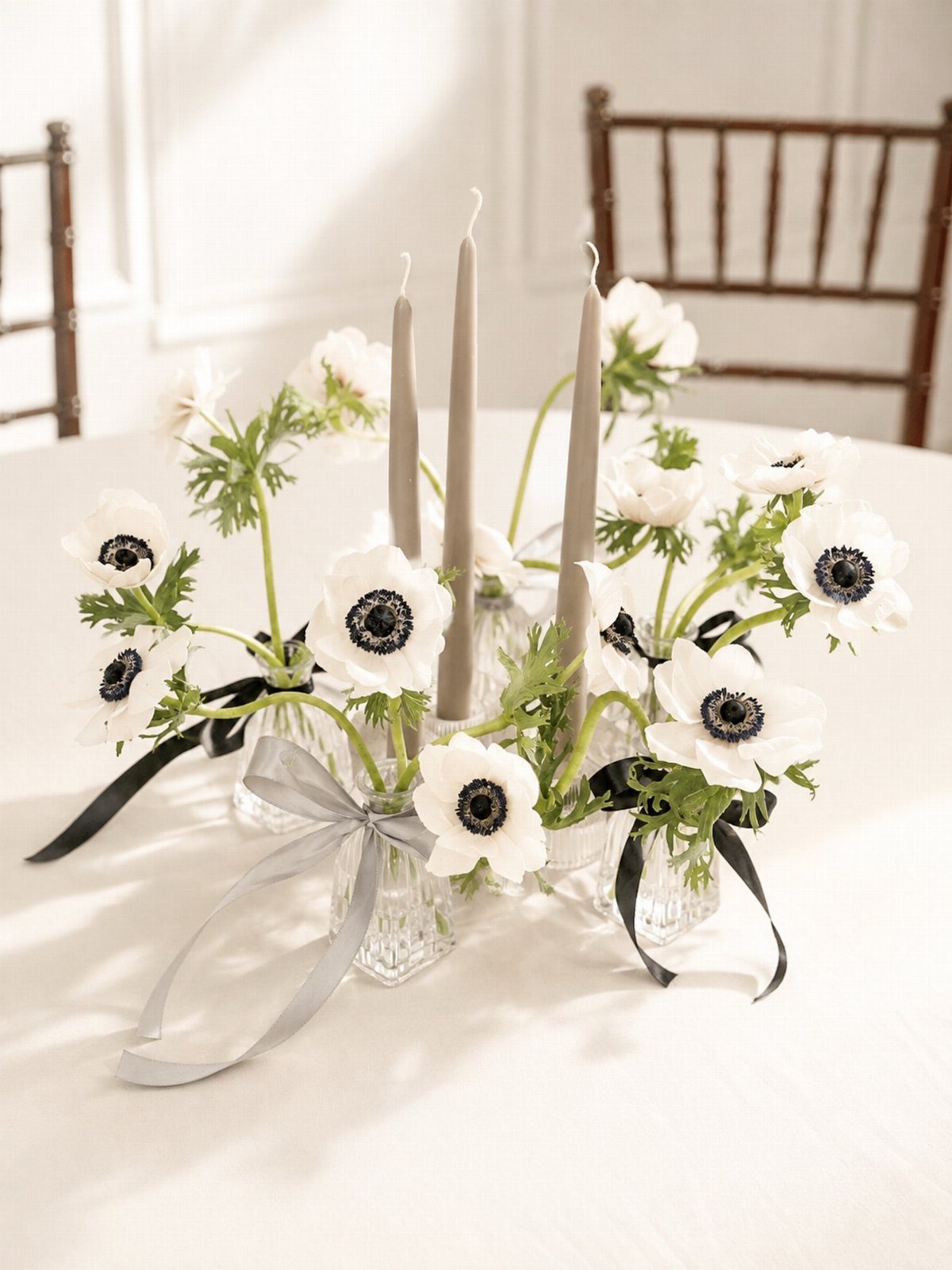 Wedding Theme Flowers: 21 Ideas for Ceremony to Cake 4 White anemones with dark centers arranged in small glass vases with grey taper candles.