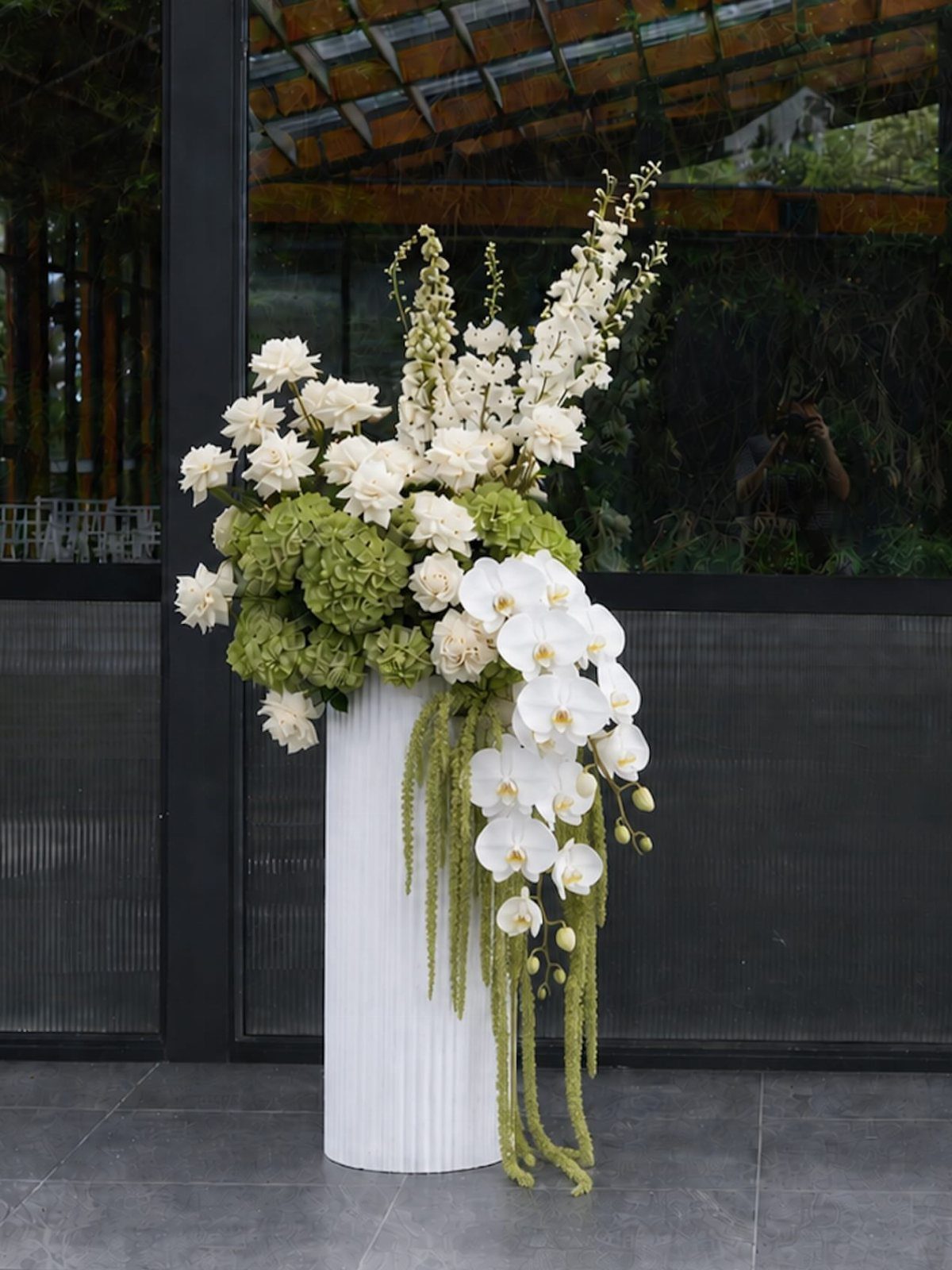 Wedding Theme Flowers: 21 Ideas for Ceremony to Cake 11 White orchids and green hydrangeas arranged in a tall white pedestal vase.