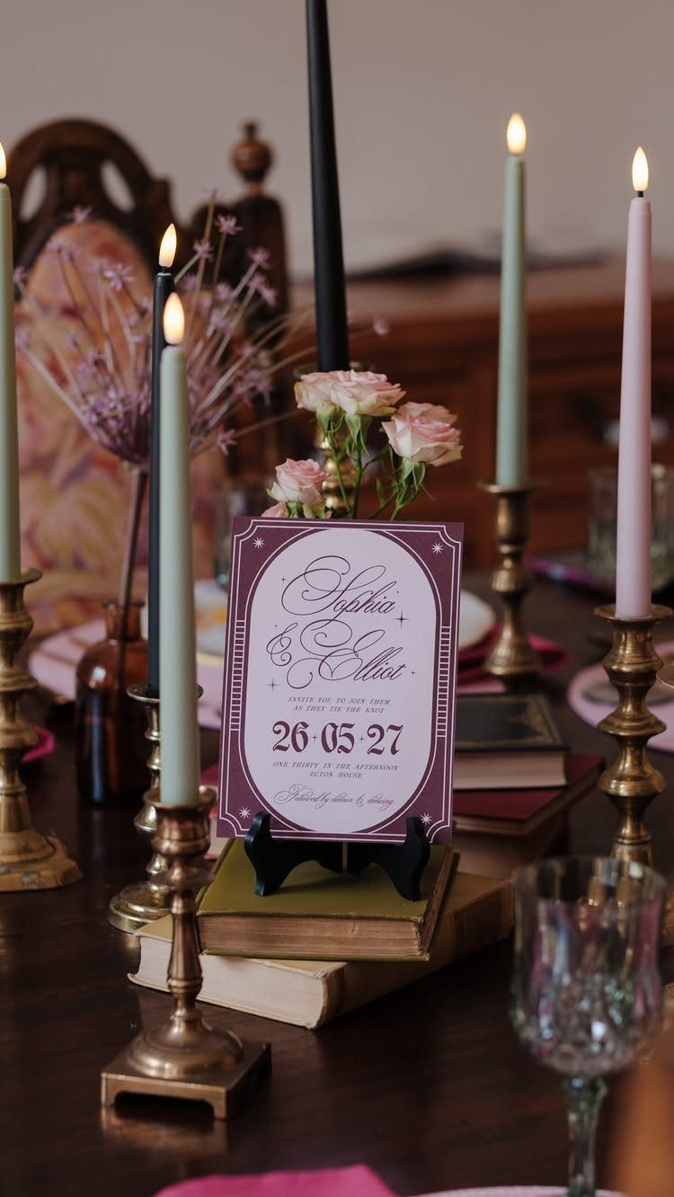 Wedding Theme and Motif: 16 Fresh Ideas for 2026 17 Vintage wedding table setting with taper candles, old books, and a purple menu card.