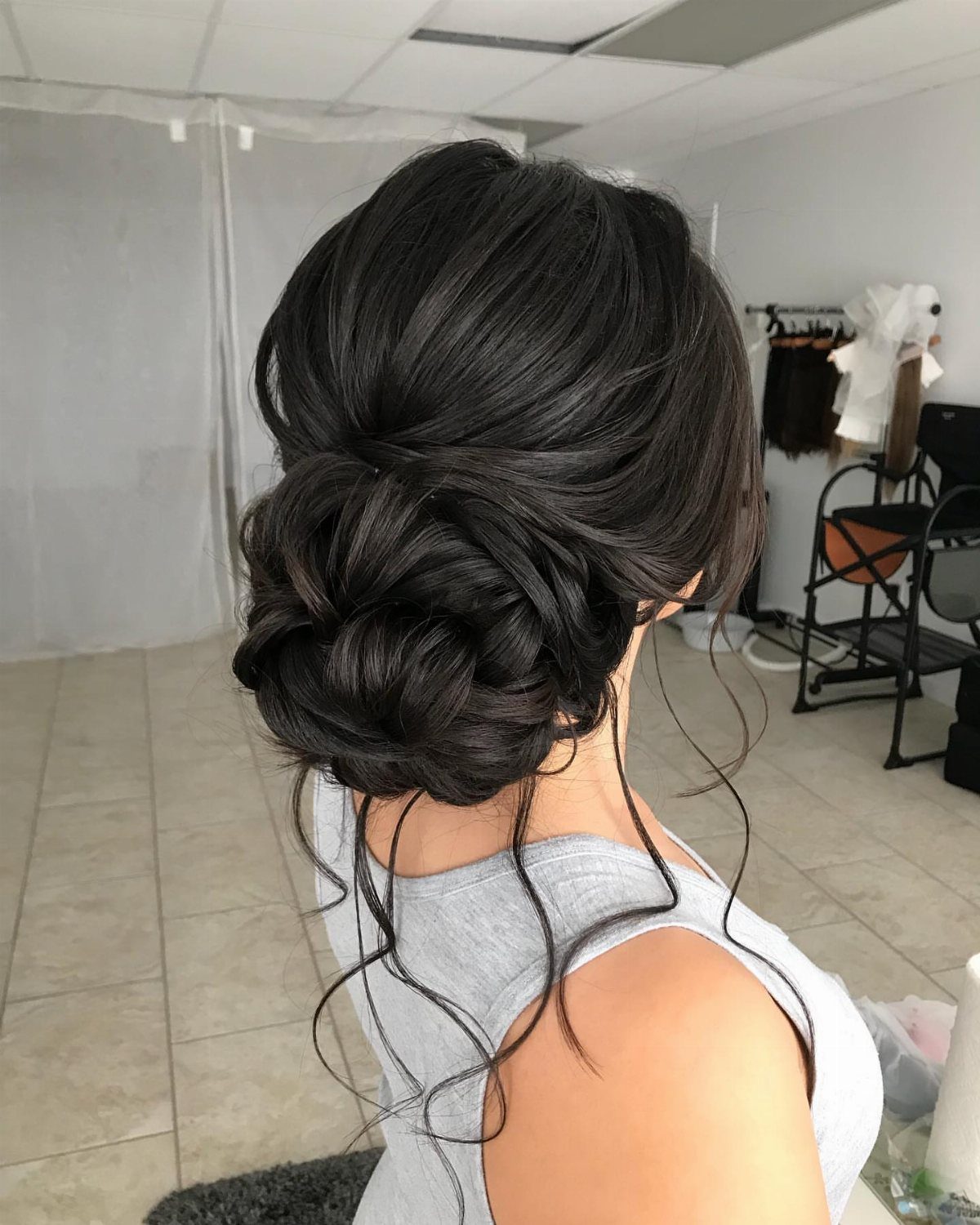 27 Bridesmaid Wedding Updo Hairstyles from Buns to Braids 20 Dark hair styled in a voluminous low looped updo with soft curls.