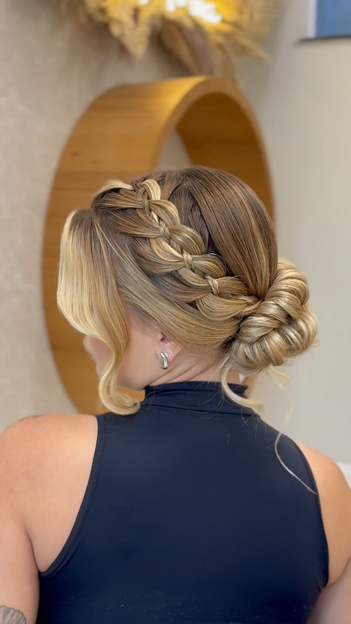 27 Bridesmaid Wedding Updo Hairstyles from Buns to Braids 13 Blonde hair styled in a thick braid ending in a low side bun.
