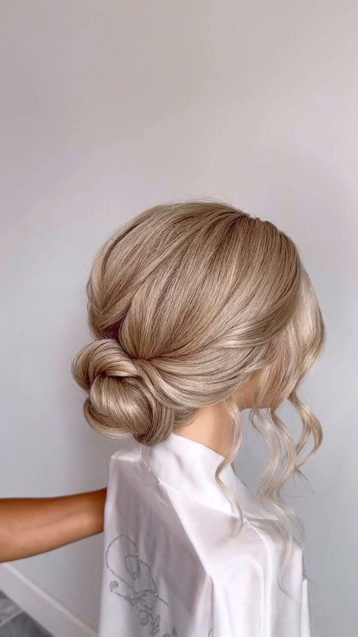 Wedding Updo Low Bun: How to Style 17 Beautiful Ideas 14 Blonde low bun with loose curls and a soft, lived-in texture for a bride.
