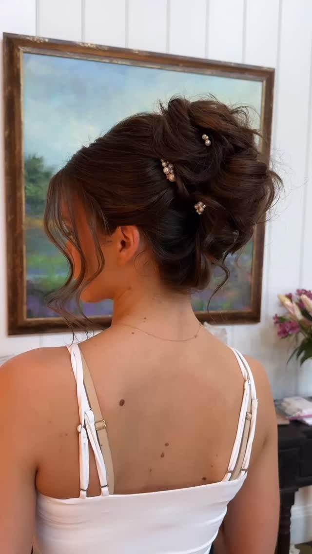 Wedding Updo Low Bun: How to Style 17 Beautiful Ideas 16 Woman's brown hair styled in a low textured bun with pearl hair accessories.