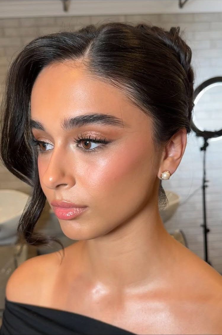 Wedding Updo Low Bun: How to Style 17 Beautiful Ideas 18 Woman with dark hair styled in a low bun and a side-swept curl.