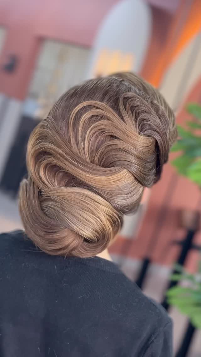 Wedding Updo Low Bun: How to Style 17 Beautiful Ideas 13 Sculpted low bun with deep glossy waves on light brown hair from behind.