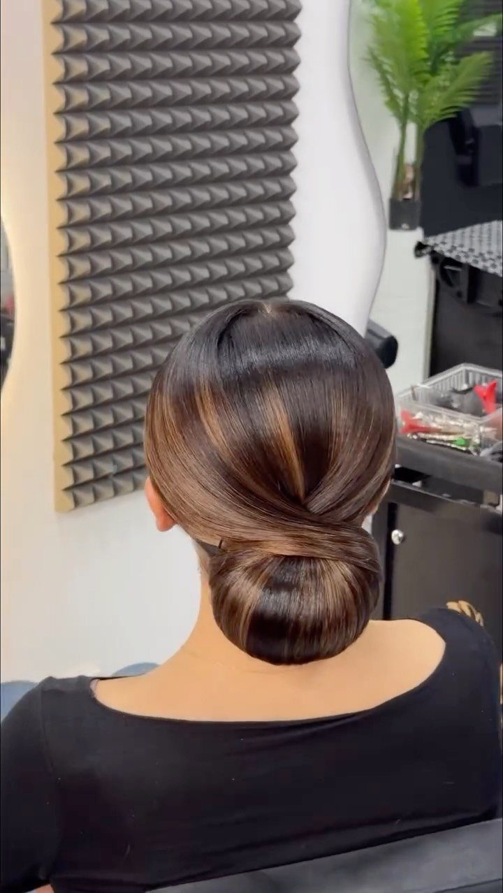Wedding Updo Low Bun: How to Style 17 Beautiful Ideas 2 Sleek low bun hairstyle on dark brown hair gathered at the nape of neck.